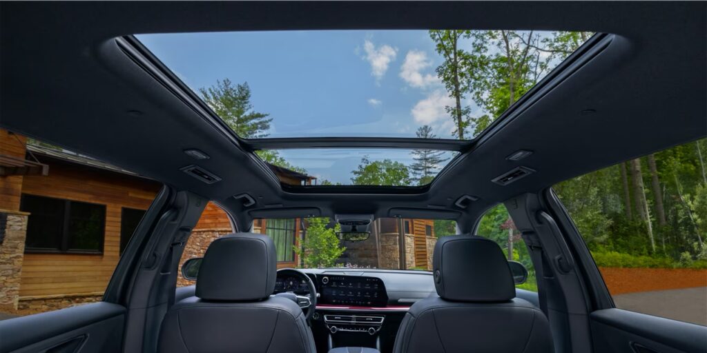 The interior of the Chevrolet SUV, showing the dashboard, seats and roof.