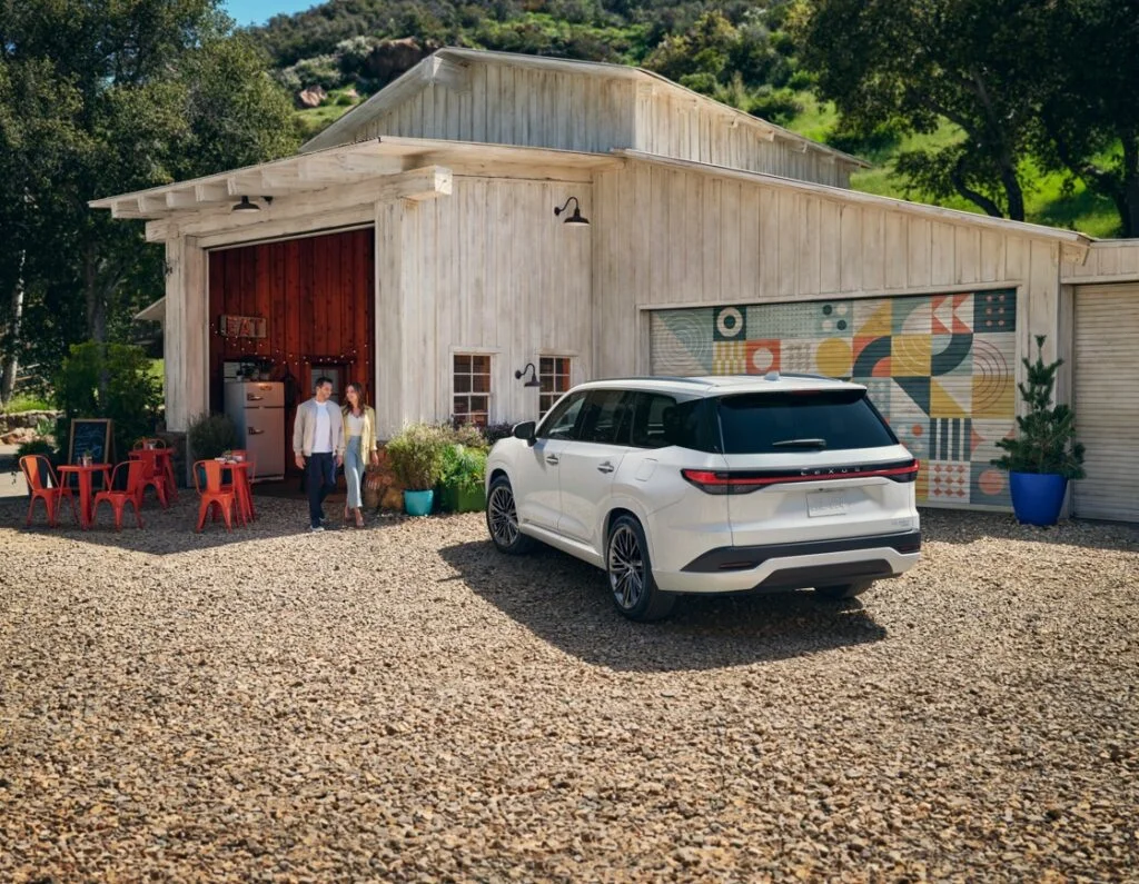 The 2024 white Lexus TX 350, parked outside a country house.