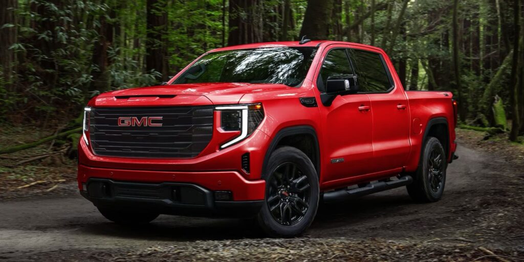 A red GMC Sierra 1500 in the woods